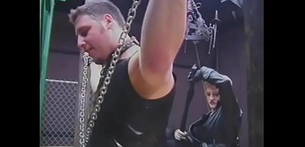  Leather-clad dominatrixes restrain and punish male slave in BDSM chamber